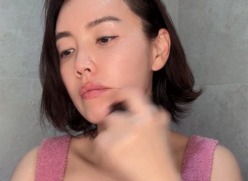 Start at the area around your mouth, sweep upward along the cheekbones and cheek line, then gently glide down from under the ears to the collarbone. Repeat about 10 times on each side to contour the face and create a natural lifting effect.
